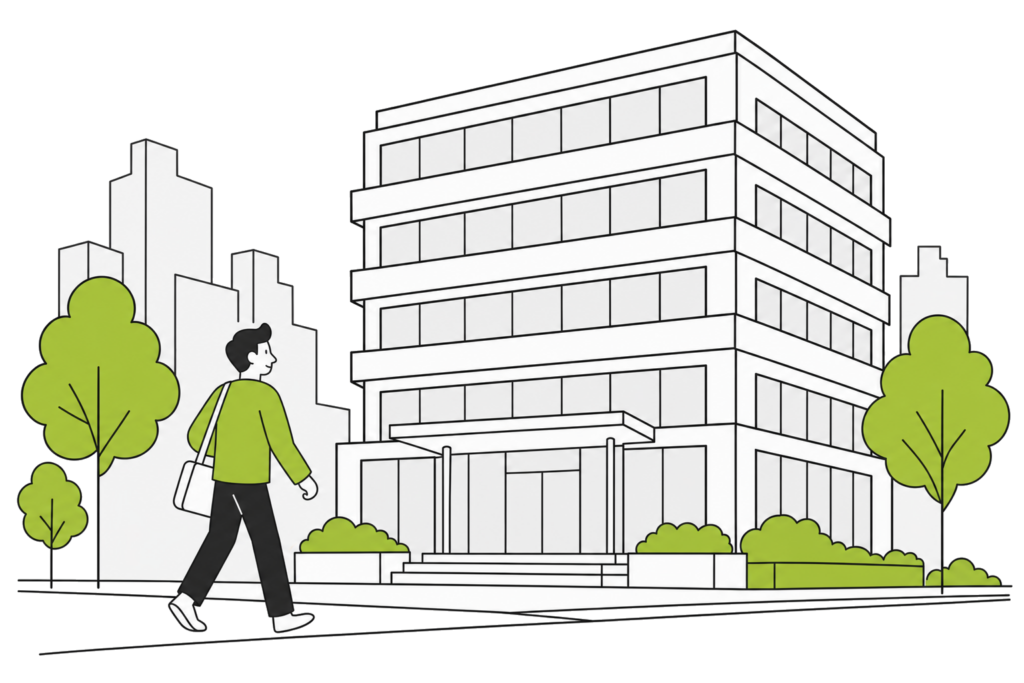 Une personne marche vers l’entrée d’un immeuble de bureaux dans une rue du centre-ville